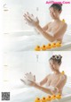 A woman in a bathtub with rubber ducks in it.