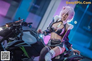 A woman sitting on top of a motorcycle in a room.